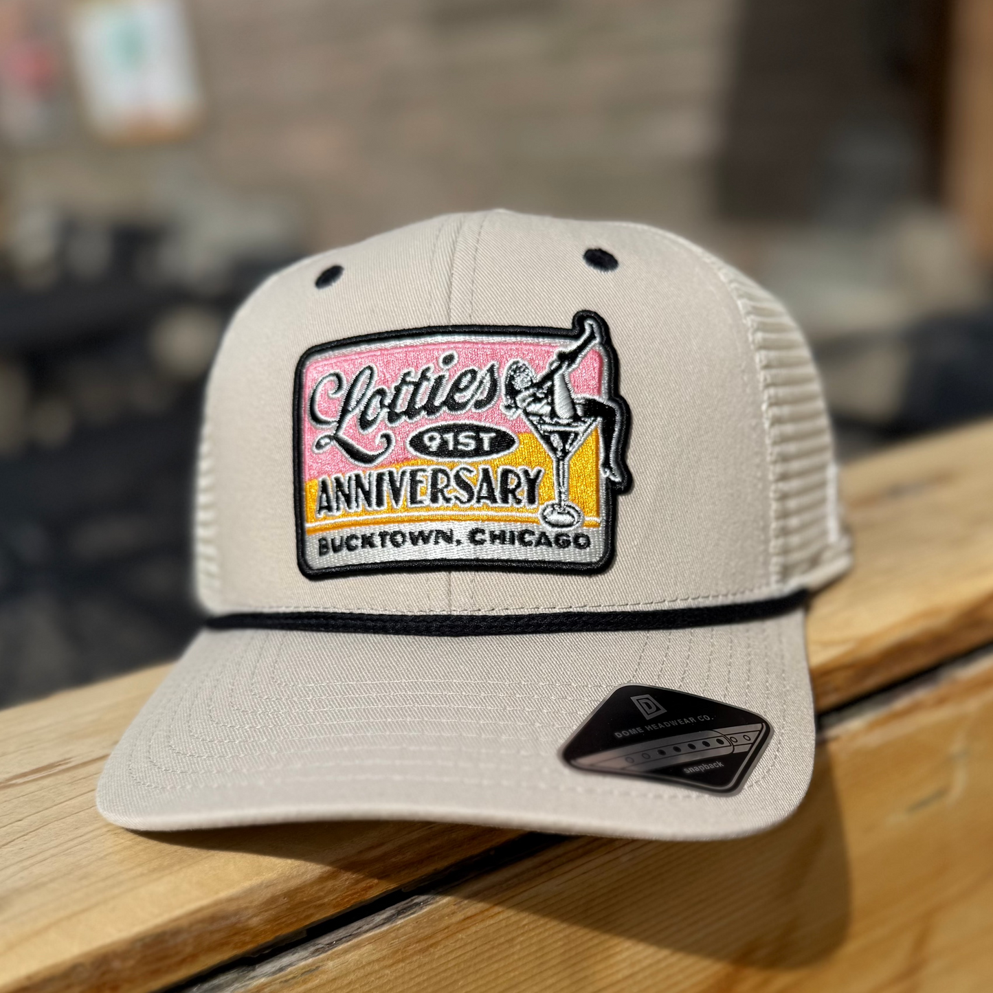 Lotties 91st Anniversary Hat. Sandstone Lotties Hat with black rope and Limited Edition Lotties 91st Anniversary patch with black trim. Lotties located in Bucktown, Chicago.