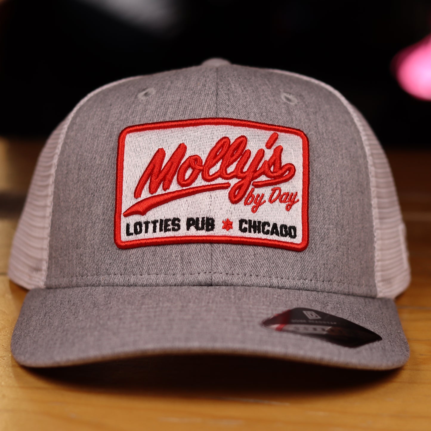 Molly's By Day Lotties Cap, an ode to Molly’s Pub, the beloved bar from Chicago Fire where Firehouse 51 comes together off the clock.