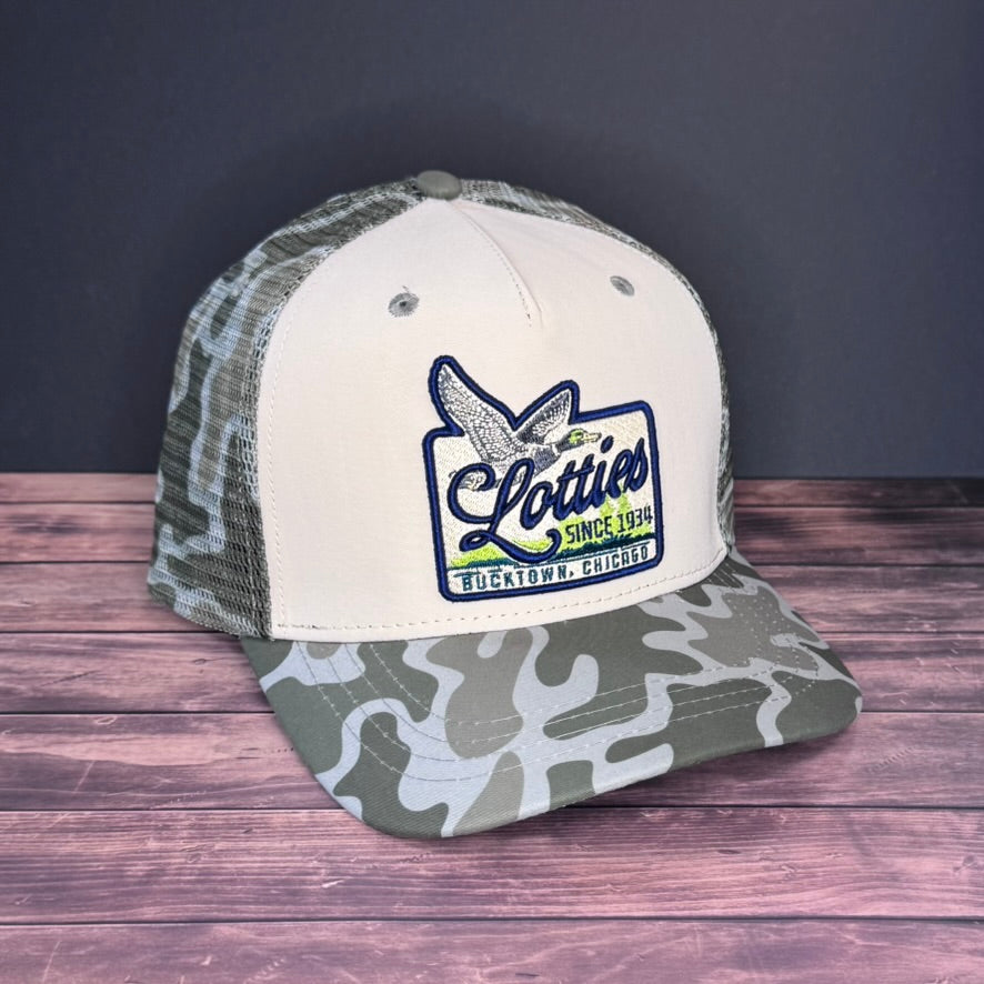 Trucker hat with camouflage brim and white front panel on a wooden surface with dark background