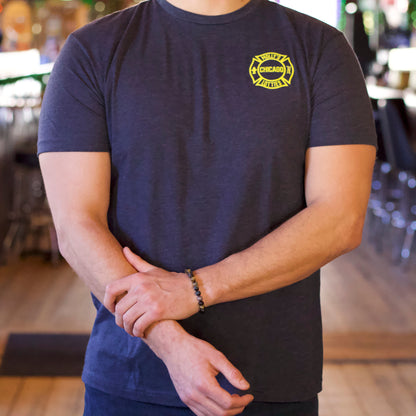 Official Lottie's t-shirt featuring the "Molly's By Day, Lottie's By Night" design with a vintage firefighter helmet. Show your Chicago pride! 